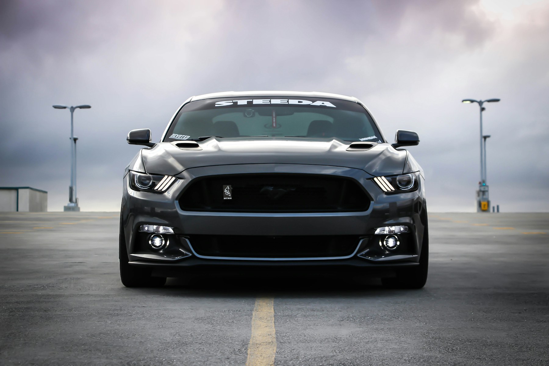 Ceramic window tint on a dark vehicle with glass reflections